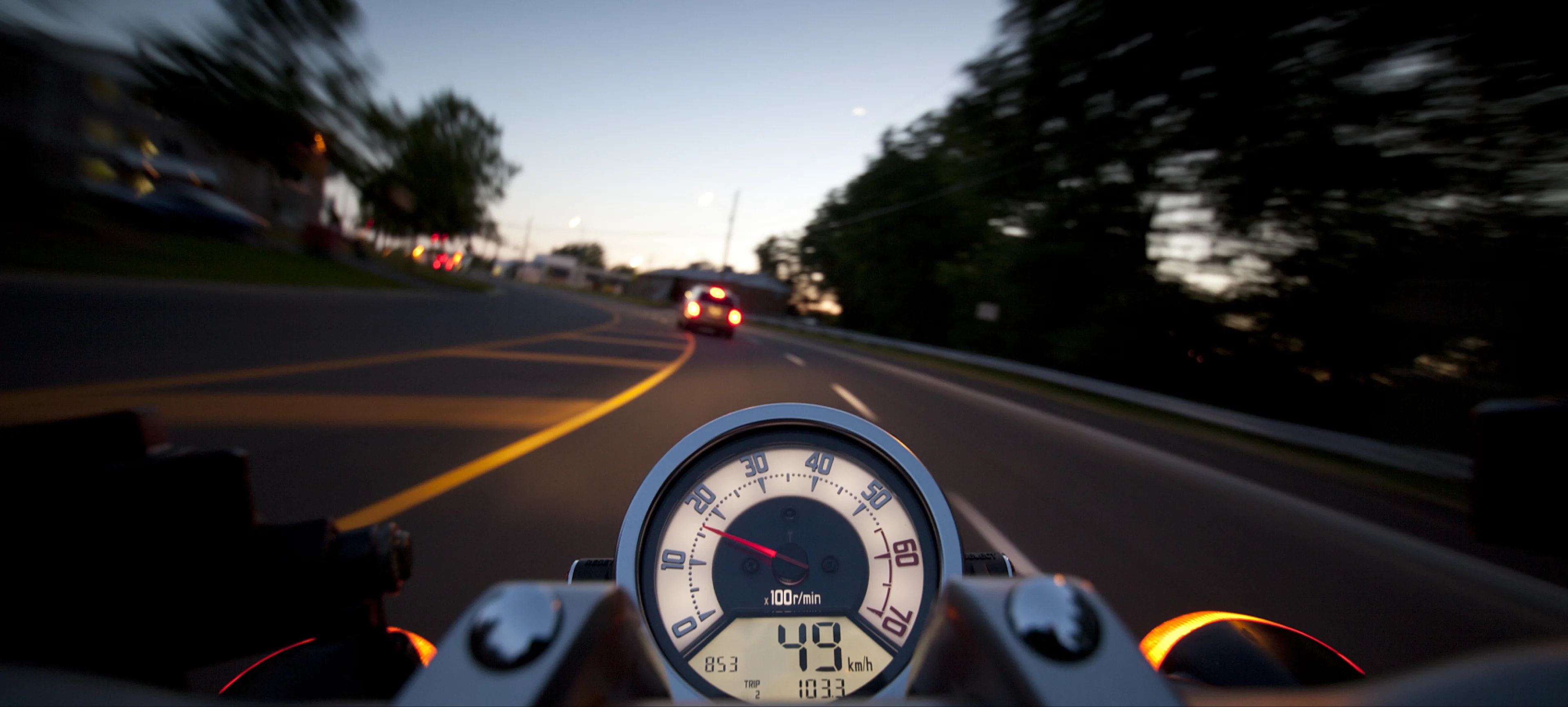 A motorcycle travelling along a forest road