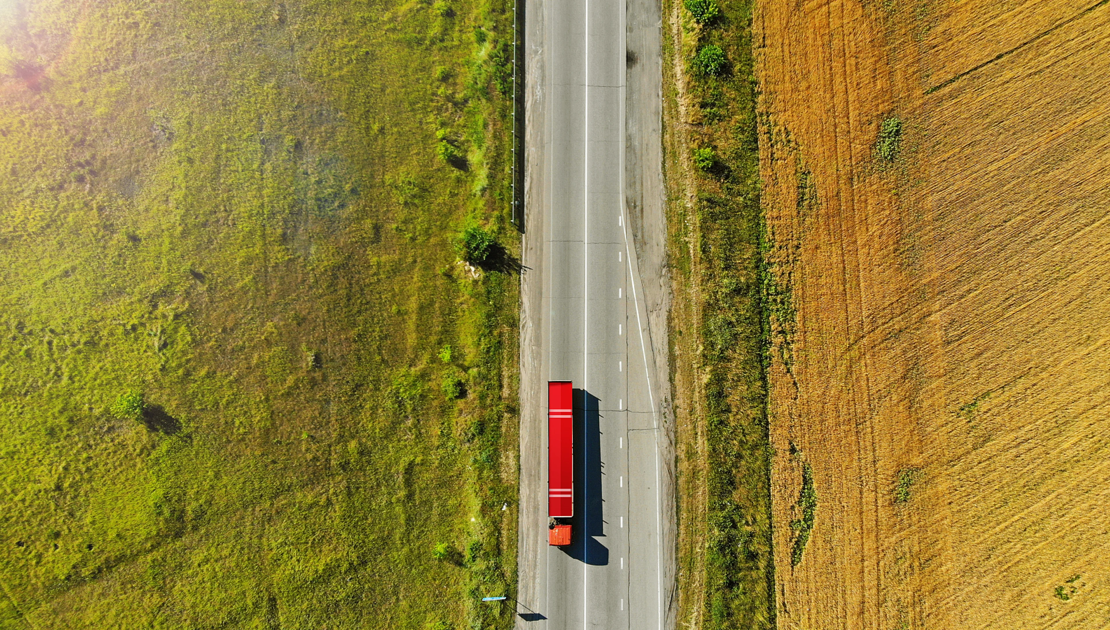 An intelligent freight truck travelling through the countryside
